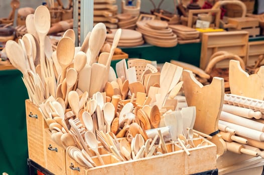 Group of wooden cooking spoons on sale at market