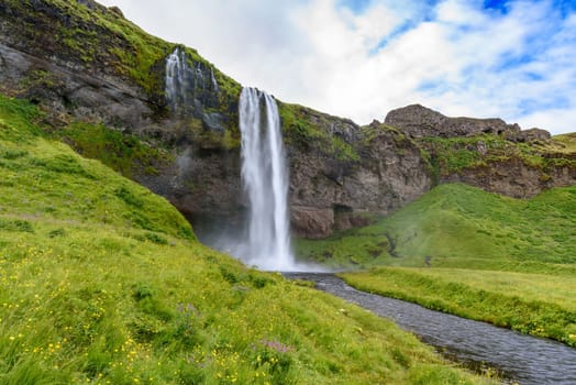 view of beautiful waterfall Seljalandsfoss in summer, south Iceland  selective focus