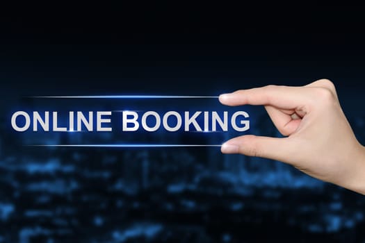 hand pushing online booking button on blurred blue background