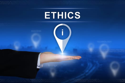 Ethics button with business hand on blurred background