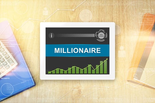 millionaire word on tablet with soft light vintage effect