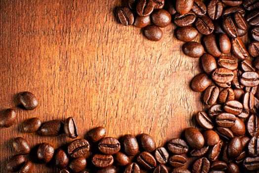 Coffee beans on a wooden background close up