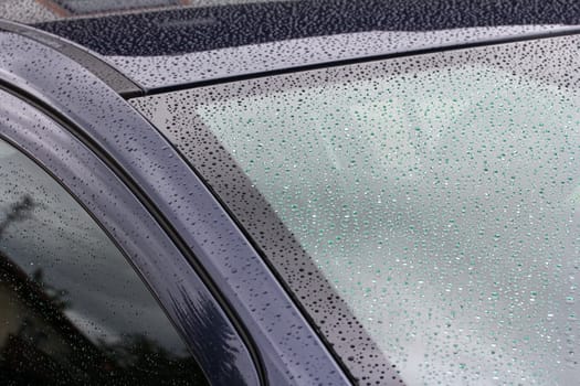 Rainy weather and road traffic - raindrops on a car
