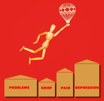 The wooden man flying over problems, grief, pain, depression with airship on red background