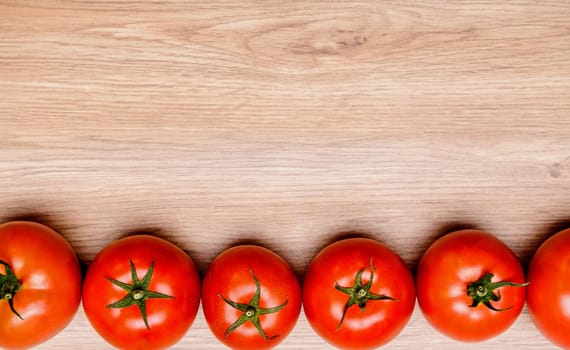 red tomatoes on wooden ground from above