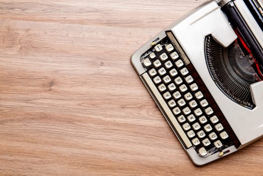 old typewriter on wooden ground from above