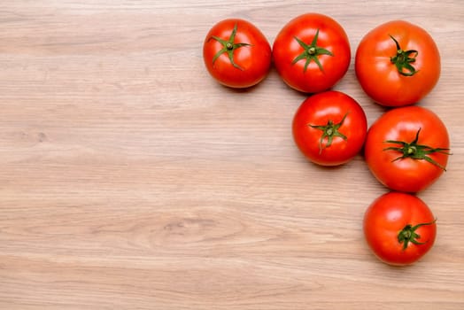 red tomatoes on wooden ground from above