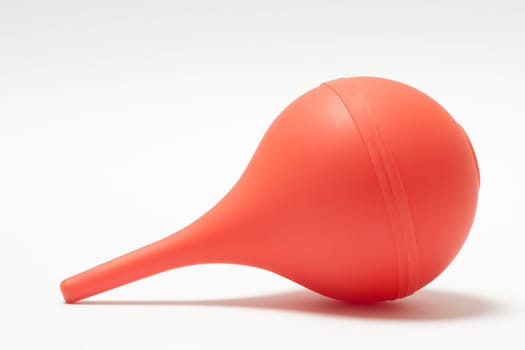 Medical enema orange on a white background