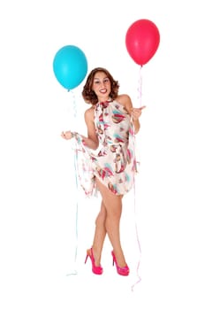 A gorgeous young woman standing in a dress with balloons attached.lifting her dress, isolated for white background..