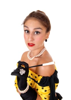 A beautiful young woman in a yellow dress holding a long cigarette holder.standing isolated for white background..