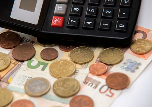 close up of euro currency. coins,banknotes and calculator