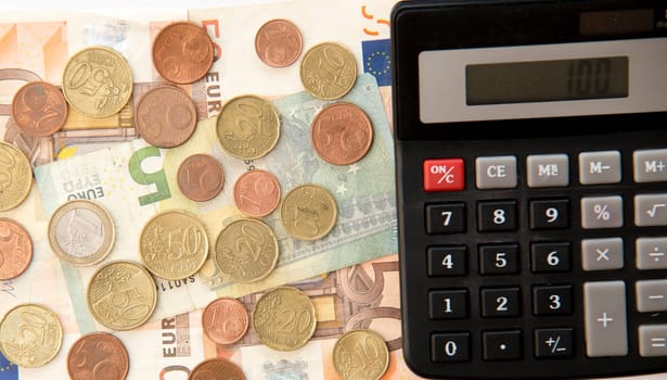 close up of euro currency. coins,banknotes and calculator