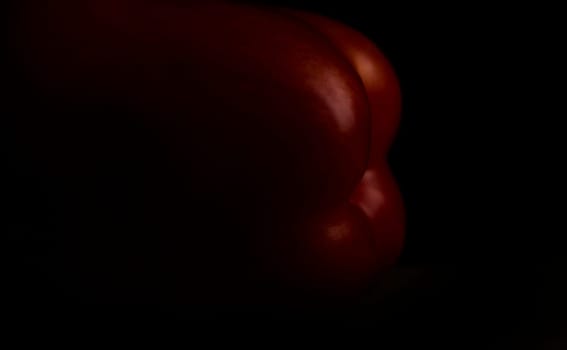 close up on dark paprika on wood,black background