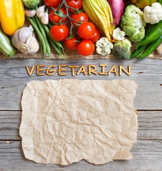 Fresh vegetables and wooden letters on an old wooden table