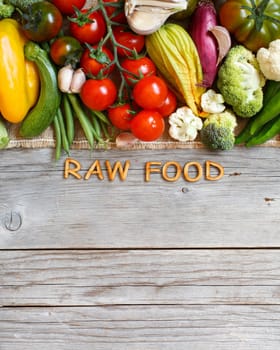 Fresh vegetables and wooden letters on an old wooden table