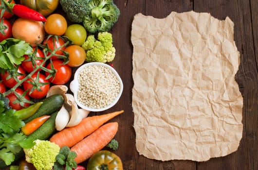White sorghum grain in a bowl with vegetables and craft paper on wood