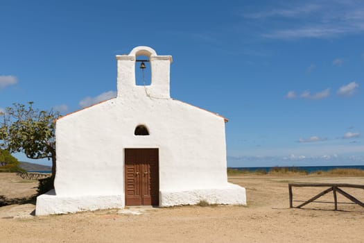 Posada, Italy - September 08, 2016: Posada - Church of Saint Lucia, Posada. North Sardinia. Small church with a single nave, the white facade with the entry portal which is surmounted by a large belfry.