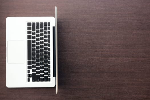 laptop computer with blank space on wood desk top view