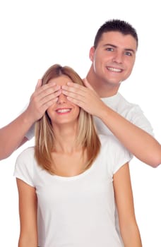 Smiling boy covering his girlfriend's eyes to surprise him isolated on a white background