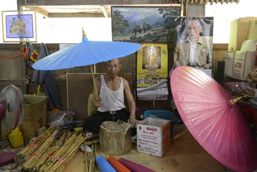 A picture of the King Bhumibol in an Umbrella Factory in the city of Chiang Mai in Thailand in Southeastasia.