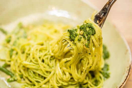 Italian pasta with pesto sauce close-up. Shallow dof.