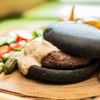 Delicious burger with beef, tomato, lettuce and fries. selective focus