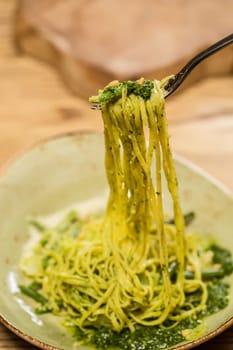 Italian pasta with pesto sauce close-up. Shallow dof.