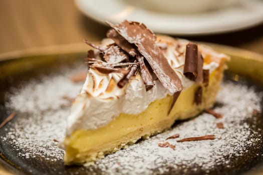 Cheesecake with Chocolate, baked to perfection. On plate with terracotta background.