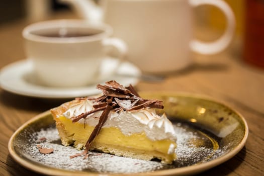 Cheesecake with Chocolate, baked to perfection. On plate with terracotta background.