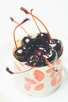 vanilla dessert with cherry confiture. Warm colors. Shallow dof.