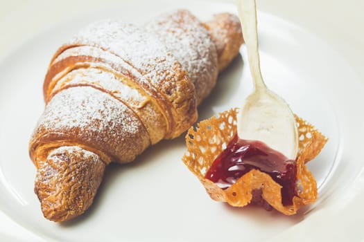 breakfast with croissant. Warm colors. Shallow dof.