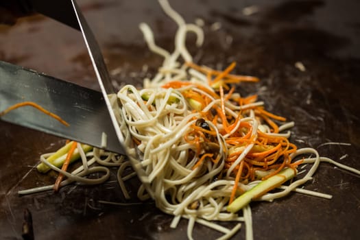 Preparing pad thai at a street hawker mobile restaurant in Bangkok, Thailand. Fried noodle. Shallow dof.