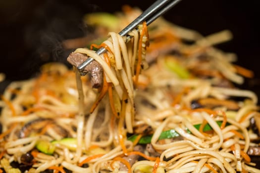 Preparing pad thai at a street hawker mobile restaurant in Bangkok, Thailand. Fried noodle. Shallow dof.