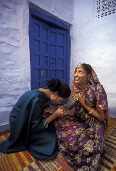 a woman is making henna in the town of Jaisalmer in the province of Rajasthan in India.