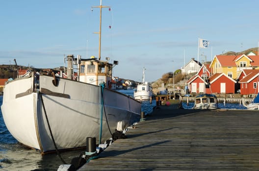 A fishingboat and other boats in a harbour in westcoast sweden