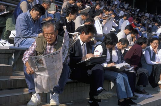 people play for money at the horserace in the City Centre of Hong Kong in the south of China in Asia.