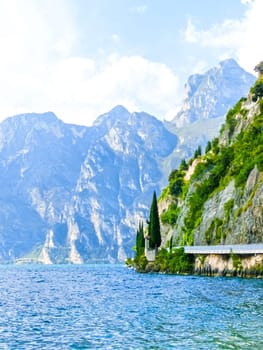 High mountains and walkway on the shore, Lake Garda, Italy, Europe