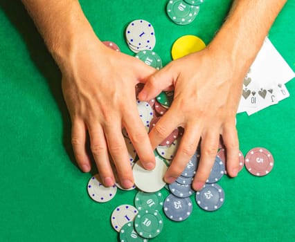 The male hands with cards in casino and chips