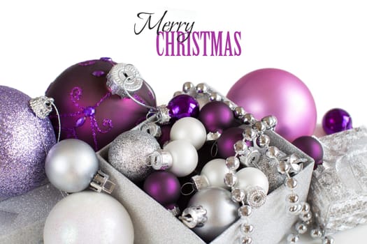 Silver and purple Christmas ornaments border on white background