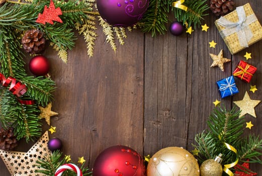 Christmas composition with decorations and paper on wood