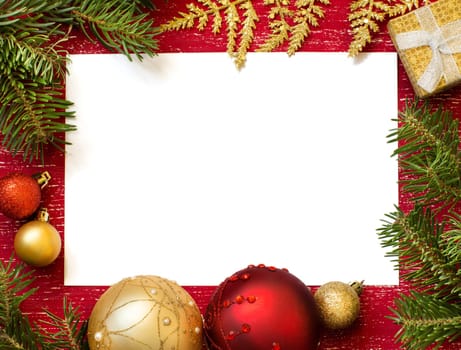 Christmas composition with decorations and paper on wood