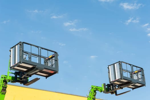 Forklift telescopic boom with buckets and aerial working platform.
