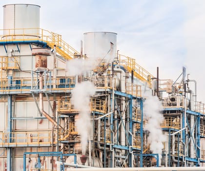 Chemical plant of a factory. Smokestacks ,pipes and tank.