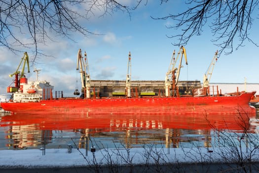 A big cargo ship reflecting on a river