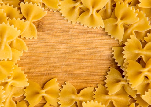 closeup of uncooked italian pasta frame - farfalle