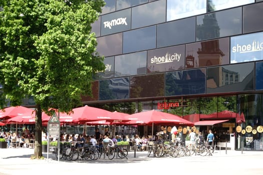 Berlin,Germany - May 10,2016: Guests and visitors sit in summer weather in the coffee house La Luna on Alexanderplatz with ice cream and refreshment on May 10,2016 in Berlin.