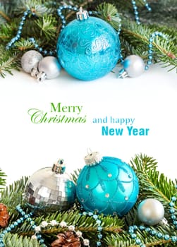 Turquoise and silver Christmas ornaments border on white background