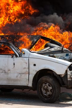 burning old white car - Exercise firefighters