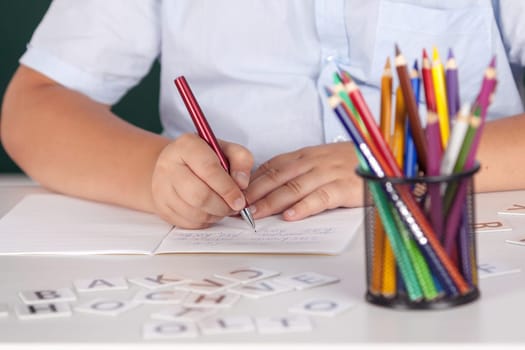 Young boy at school writing assignment