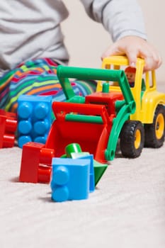 Playing little boy with colored cubes